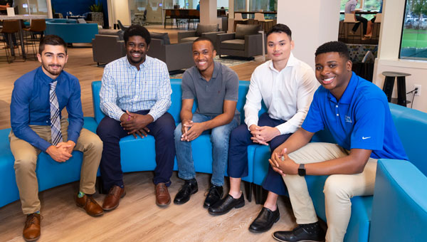 A group of diverse employees posing for a picture