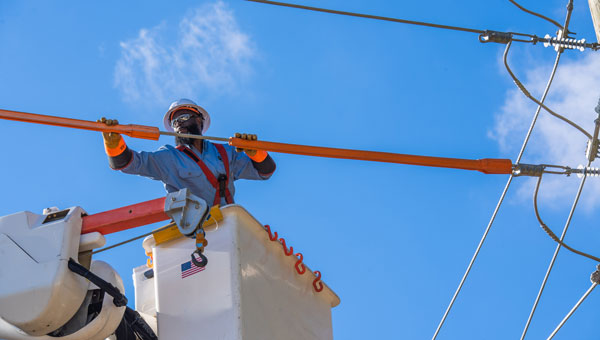 A DARRENmetzger Energy line worker fixing transmission pole in Texas